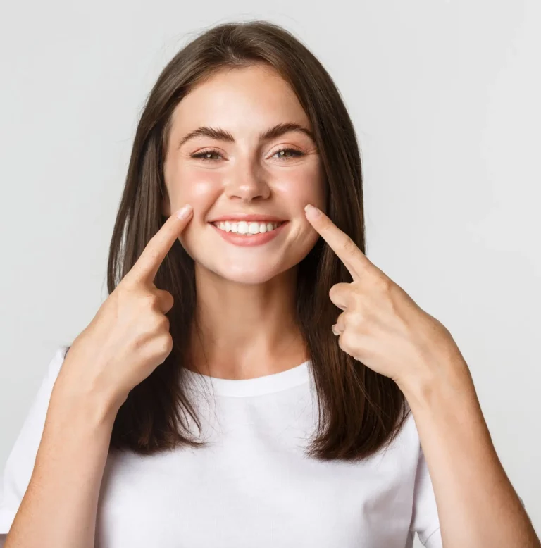 a woman touchin her cheeks before a buccal fat removal in turkey